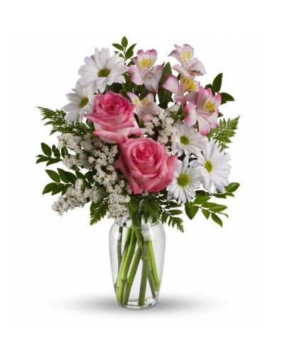 <p>Celebrate someone special with a bouquet as charming and delightful as they are. This lovely arrangement features soft pink roses, pink alstroemeria, and crisp white mums, artfully arranged in a sparkling clear glass vase.</p>