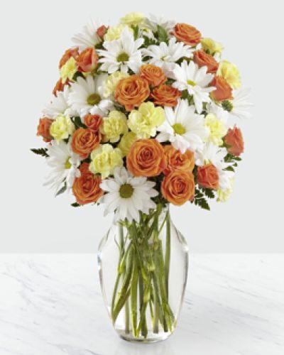 <p>Designed to bring a smile to any occasion, it combines bold hues with classic blooms in a way that feels refreshing and unforgettable. The arrangement features crisp white daisies as a soft, cheerful backdrop for vivid orange spray roses and bright yellow mini carnations.</p>