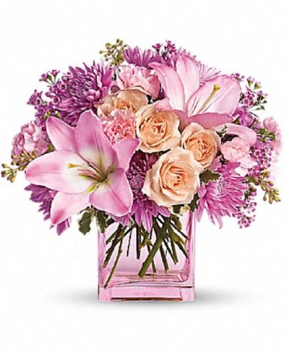 <p>Surprise someone with a bouquet as pretty as a dream and filled with delightful charm. The design features a lovely mix of peach roses, pink Asiatic lilies, miniature carnations, lavender cushion spray chrysanthemums, and waxflower.</p>