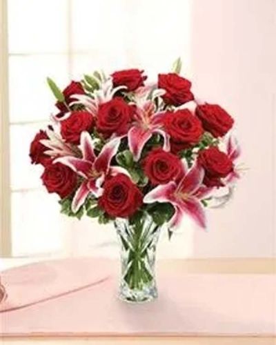 <p>This elegant arrangement features long-stemmed red roses and graceful lilies, hand-gathered with fresh pittosporum and carefully styled in a dazzling heirloom crystal vase. The rich reds and soft whites create a stunning visual contrast, while the crystal vessel adds lasting value and classic charm to this romantic gift.</p>