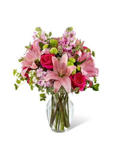 <p>The bouquet features a striking mix of hot pink roses that add vibrant flair, softened by pale pink Asiatic lilies for an elegant touch. It arrives in a classic clear glass vase that keeps the focus on the flowers and works beautifully in any setting, from a cozy breakfast nook to a modern workspace.</p>