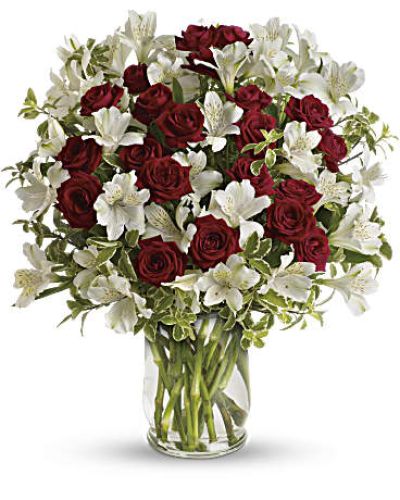 <p>This bouquet captures that sentiment perfectly with passionate red spray roses and delicate white alstroemeria, elegantly arranged in a clear glass hurricane vase. The arrangement features vibrant red spray roses symbolizing love and admiration, paired with soft white alstroemeria for balance and beauty.</p>