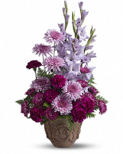 <p>Thhis design showcases an elegant mix of lavender and purple blooms, including gladioli, carnations, and cushion spray chrysanthemums. Accented with graceful ferns, these flowers are arranged thoughtfully to create a full and balanced display.</p>