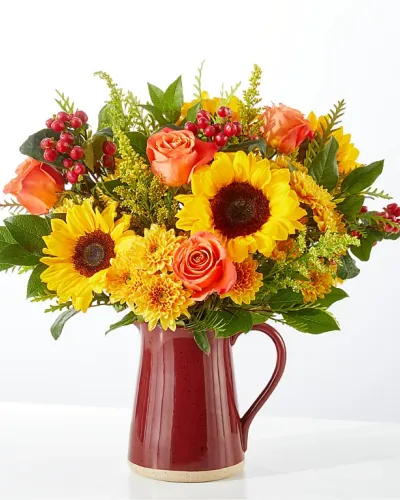 <p>Charming and rustic, the Scents of Autumn Bouquet welcomes the beauty of the changing seasons indoors, warming up any space with sunny shades of sunflowers, cushion poms and solidago.</p>