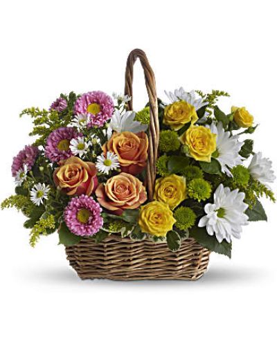 <p>Send a wave of peace and happiness with this colorful floral basket designed to lift spirits and brighten any room. The arrangement features a blend of orange and yellow roses, pink matsumoto asters, white daisies, green button mums, and white monte cassino asters.</p>