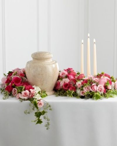 <p>Celebrate a life filled with love and kindness through this beautifully designed floral arrangement that surrounds the urn with elegance and warmth. Fuchsia and pale pink roses, along with matching spray roses, form the heart of the design.</p>