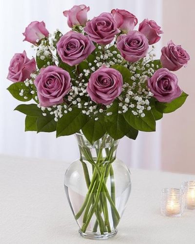 <p>Delight someone special with the unique beauty of lavender roses, a symbol of enchantment and love at first sight. The bouquet features fresh lavender roses artfully arranged in a classic glass urn vase.</p>