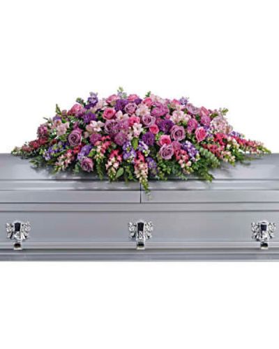 <p>Honor her femininity and generous spirit with a blanket of sweetly scented lavender, pink, and purple flowers that create a magnificent final tribute, sincerely expressing devotion and love. Gorgeous blooms such as lavender and pink roses, pink snapdragons, and alstroemeria combine with purple and lavender chrysanthemums to form a graceful, heartfelt arrangement.</p>