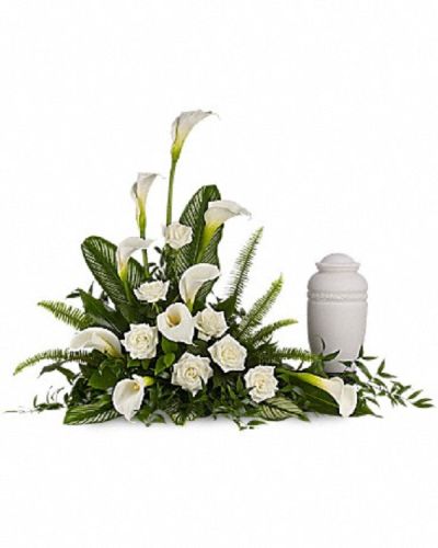 <p>Honor a beautiful life with a serene and graceful floral tribute designed to surround a cherished urn with quiet strength and elegance. Majestic white calla lilies stand tall alongside classic white roses, each bloom thoughtfully placed to express purity, remembrance, and enduring love.</p>