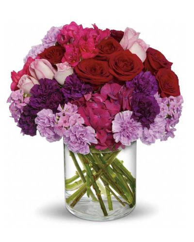 <p>This luxurious arrangement features dark pink hydrangea, red and lavender roses, deep purple and lavender carnations, hot pink freesia, and soft lavender phlox. Hand-designed in a clear cylinder vase, the mix of rich, romantic hues creates a dramatic and unforgettable presentation—perfect for sweeping someone off their feet.</p>