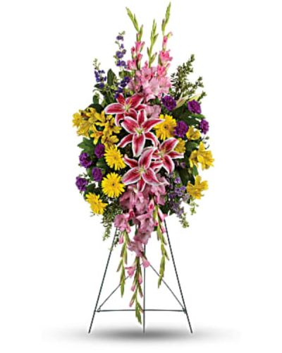 <p>Honor a life well lived with a vibrant standing spray that expresses heartfelt sympathy through beauty, color, and grace. This uplifting arrangement combines warm and soothing tones in perfect harmony, offering comfort to those who grieve while celebrating the joyful spirit of the one being remembered.</p>