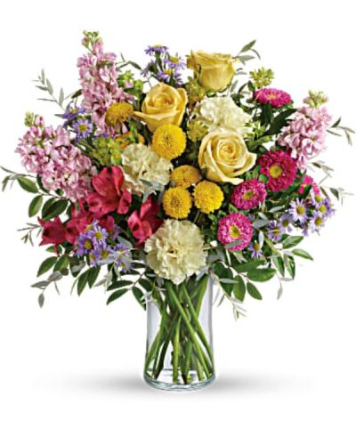 <p>This lively arrangement overflows with yellow roses and pink roses, creating a stunning foundation of warmth and sweetness. They are joined by red alstroemeria, light yellow carnations, pink stock, hot pink matsumoto asters, and lavender monte cassino asters for a full-spectrum bouquet that delights the senses.</p>