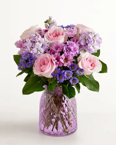 <p>Our delightful lavender bouquet is gathered with accents of pink and lush greenery in an embossed lavender vase that complements the delicate beauty of the blooms.</p>