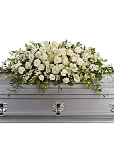 <p>Honor the life of a loved one with an all-white casket spray that radiates tranquility, reverence, and timeless beauty. Designed for a full couch or closed casket service, this large-scale arrangement offers a graceful expression of remembrance through some of nature’s most elegant blooms.</p>