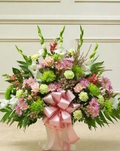 <p>This floor basket in pastel offers a soft and heartfelt way to convey sympathy with grace and sincerity. The arrangement features a hand-gathered selection of fresh pastel roses, gladiolas, snapdragons, mums, carnations, daisy poms, heather, and seasonal greenery.</p>