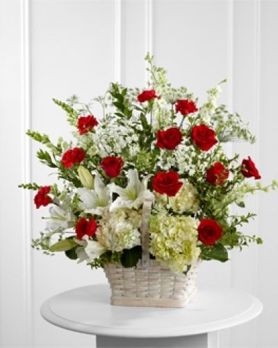 <p>The design features red roses and carnations symbolizing love and admiration, combined with soothing white Oriental lilies, hydrangeas, snapdragons, and larkspur. Each stem is hand-placed in a large whitewashed rectangular basket, chosen for its rustic elegance and timeless appeal.</p>