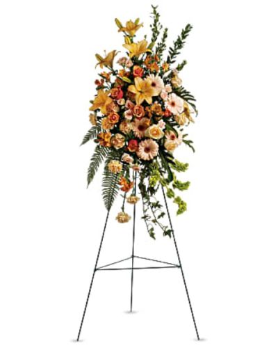 <p>This elegant spray features a lush blend of peach roses, orange bi-color roses, peach spray roses, and peach Asiatic lilies. Accents of orange alstroemeria, peach carnations, and striking bells of Ireland add depth and height, creating a gentle fountain-like shape that evokes movement and lightness.</p>