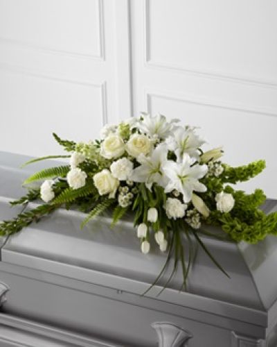 <p>Offer a message of comfort and renewal with this graceful casket spray, designed to inspire serenity and remembrance. This elegant arrangement features white tulips, roses, snapdragons, Oriental lilies, larkspur, carnations, and monte casino asters.</p>
