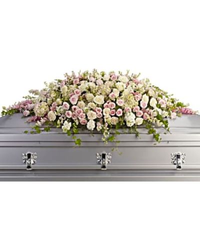 <p>Honor a radiant life with a stunning casket spray that conveys timeless love, beauty, and peace. Its gentle colors and graceful shape provide comfort during a time of sorrow while celebrating a life filled with warmth and grace.</p>