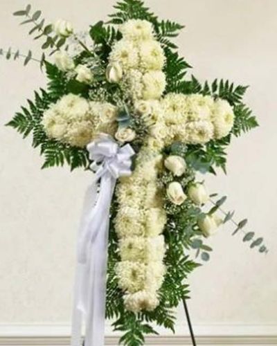 <p>The Peace & Love Standing Cross in white is a powerful tribute, offering comfort and reverence through the elegant simplicity of an all-white floral cross. This standing spray is beautifully crafted from pure white roses and lush football mums, accented with fresh greenery and soft floral details.</p>