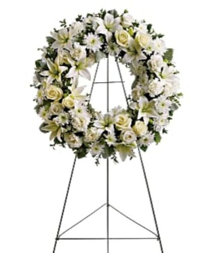 <p>Honor the gentle spirit of a loved one with a timeless wreath that symbolizes eternal love and remembrance. Composed of soft white blossoms and soothing greenery, this standing wreath offers comfort and calm during times of sorrow.</p>