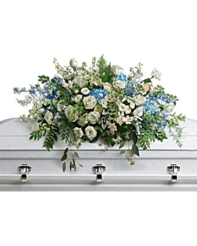 <p>Celebrate the memory of a loved one with a breathtaking standing spray designed to bring comfort, serenity, and a sense of gentle renewal. This elegant spray features soothing blue hydrangea and delphinium, paired with graceful white roses, spray roses, and alstroemeria.</p>