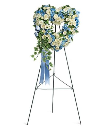 <p>Soft in color and rich in meaning, this petite 16-inch arrangement offers a graceful farewell filled with love, purity, and peace. This delicate design features sky blue hydrangea and snow white spray roses, carefully arranged to create a serene and soothing display.</p>