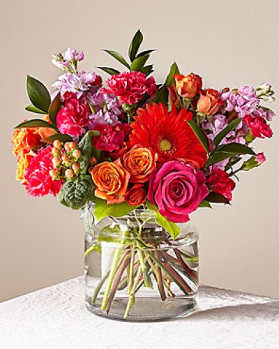 <p>There's something about a mix of warm oranges, soft peaches, and fresh pinks that feels like a celebration all on its own. The Fiesta Bouquet brings together bold gerbera daisies, classic roses, ruffled carnations, and fragrant stock in a palette that catches the light and fills a room with color and scent. It's the kind of arrangement that makes people stop mid-conversation and smile - lush, cheerful, and full of personality.</p>