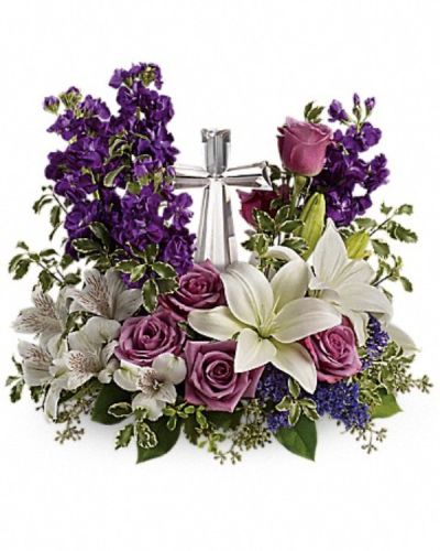 <p>Send a message of serenity and spiritual grace with this stunning floral arrangement that surrounds a keepsake Crystal Cross with elegant blooms in soft, peaceful hues. This radiant arrangement features lavender roses, white Asiatic lilies, white alstroemeria, and soft purple stock.</p>
