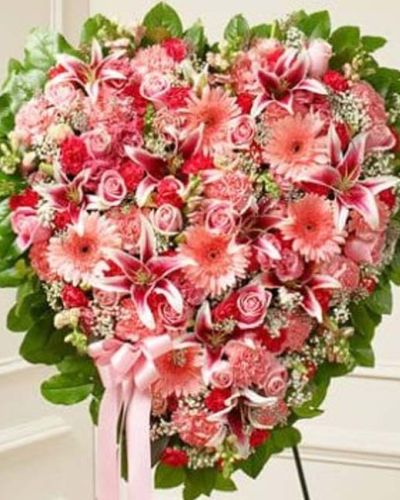 <p>The Sympathy & Support Flower Heart in pink is a soft, elegant expression of sympathy, handcrafted to offer comfort and honor a cherished life. This solid heart-shaped standing spray features a delicate blend of pink roses, stargazer lilies, Gerbera daisies, carnations, and other seasonal blooms.</p>