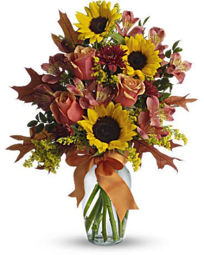<p>This sunny arrangement evokes the feeling of a golden afternoon in the countryside—filled with warmth, joy, and beauty. The bouquet features a joyful mix of golden yellow sunflowers, orange bi-color roses, dark orange alstroemeria, and rust-colored cushion spray chrysanthemums.</p>