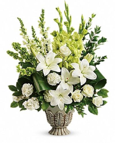 <p>This stunning floral tribute provides a graceful way to honor a life filled with light, love, and gentle strength, offering solace during difficult times. The elegant design features a harmonious blend of white roses, Asiatic lilies, carnations, snapdragons, and stock.</p>