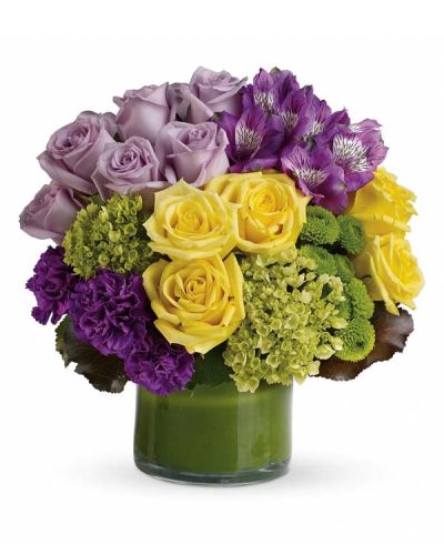 <p>This sophisticated arrangement includes miniature green hydrangea, lavender and yellow roses, purple alstroemeria, dark purple carnations, green button spray chrysanthemums, galax leaves, and a ti leaf. Each bloom is carefully arranged in a clear glass vase to highlight its natural beauty and create a fresh, modern look.</p>