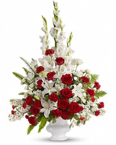 <p>This striking display features a graceful blend of red and white blooms, including fresh roses and seasonal flowers. Soft touches of greenery add natural balance and texture, while the classic white vase provides an elegant foundation.</p>
