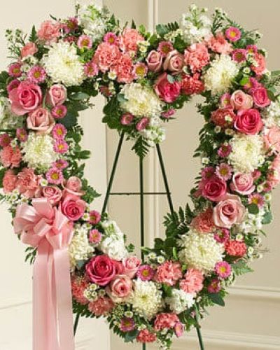 <p>Commemorate a cherished life and the special place they hold in your heart with this heart-shaped floral arrangement. Expert florists craft this beautiful tribute using fresh pink and white flowers, including roses, stock, carnations, and more.</p>