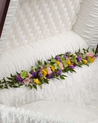 <p>Soft and graceful, this casket adornment offers a delicate way to express love and honor during a final farewell. Designed to rest along the inside edge of the casket, it brings warmth and serenity to the service with its thoughtful presence.</p>