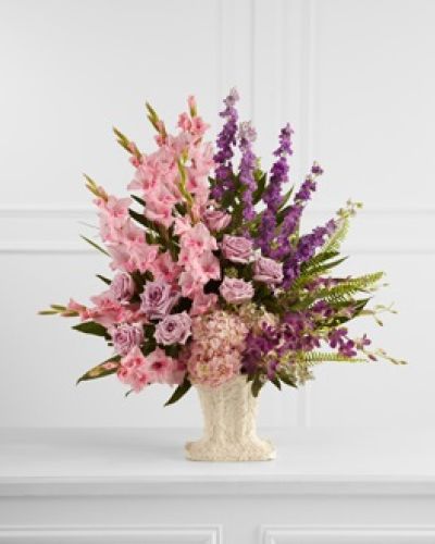 <p>This lush and expressive arrangement honors a life filled with beauty, compassion, and unforgettable moments. The design features a harmonious blend of lavender roses, pink gladiolus, purple dendrobium orchids, purple larkspur, and pink hydrangea.</p>