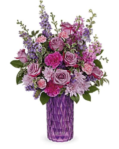 <p>This luxurious design features a lush combination of lavender roses, purple larkspur, soft pink stock, and rich purple carnations. Lavender cushion chrysanthemums and miniature pink carnations add texture and depth, while accents of purple statice, lemon leaf, and pitta negra bring balance and a touch of natural greenery.</p>