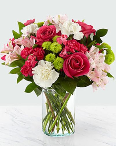 <p>This bouquet features a harmonious blend of hot pink roses, pale pink alstroemeria, and seasonal accent flowers. Presented in a simple yet elegant glass cylinder vase, the design balances sophistication with playfulness.</p>