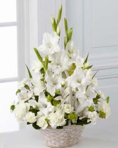 <p>This bouquet features a calming collection of white blooms symbolizing purity, remembrance, and eternal love. Tall white gladiolus add elegance and stature, while clusters of white Peruvian lilies, traditional carnations, and miniature carnations bring softness and depth.</p>